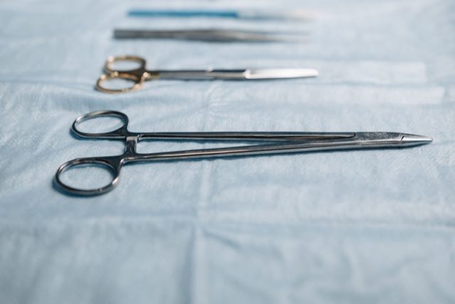 Sterile surgical instruments laid out on a draped tray