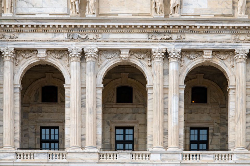 Marble columns and arches of a neoclassical government building