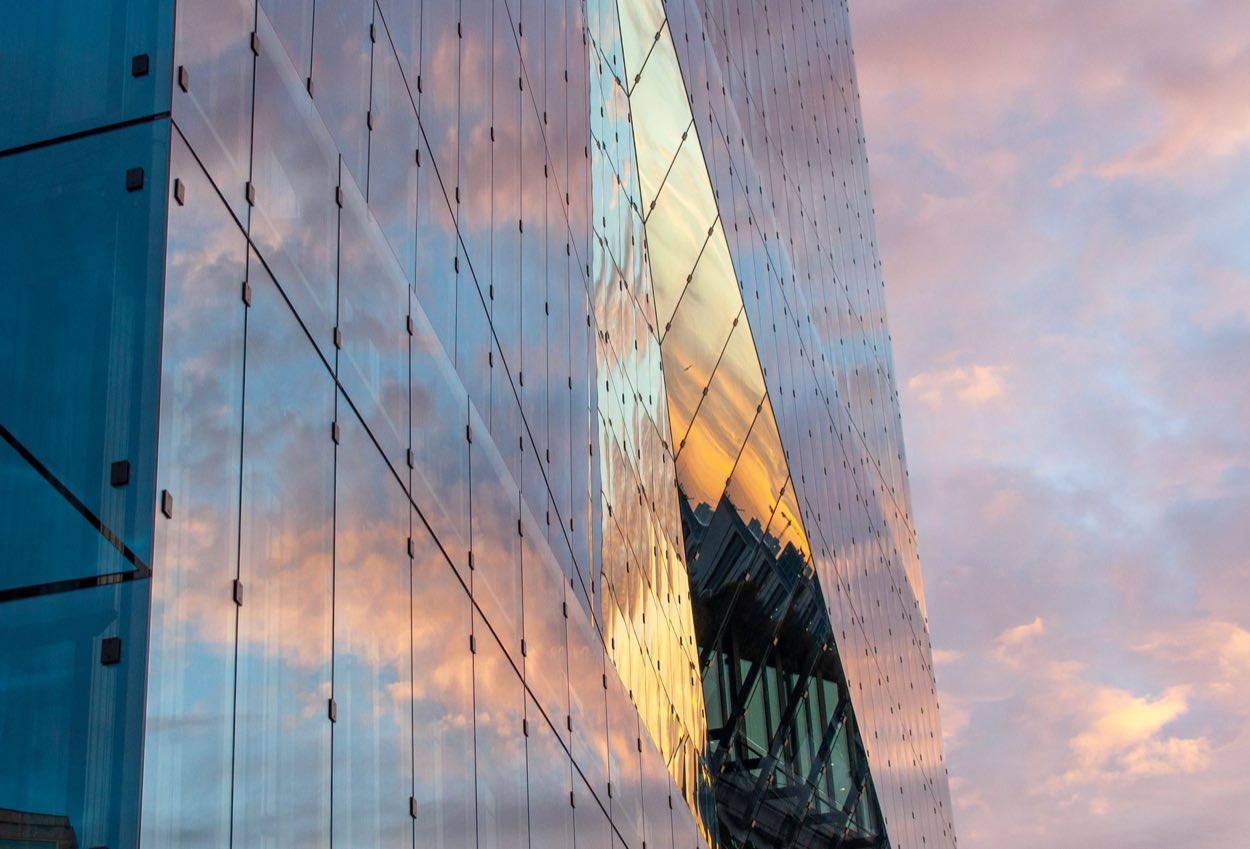 Glass tower catching golden evening light