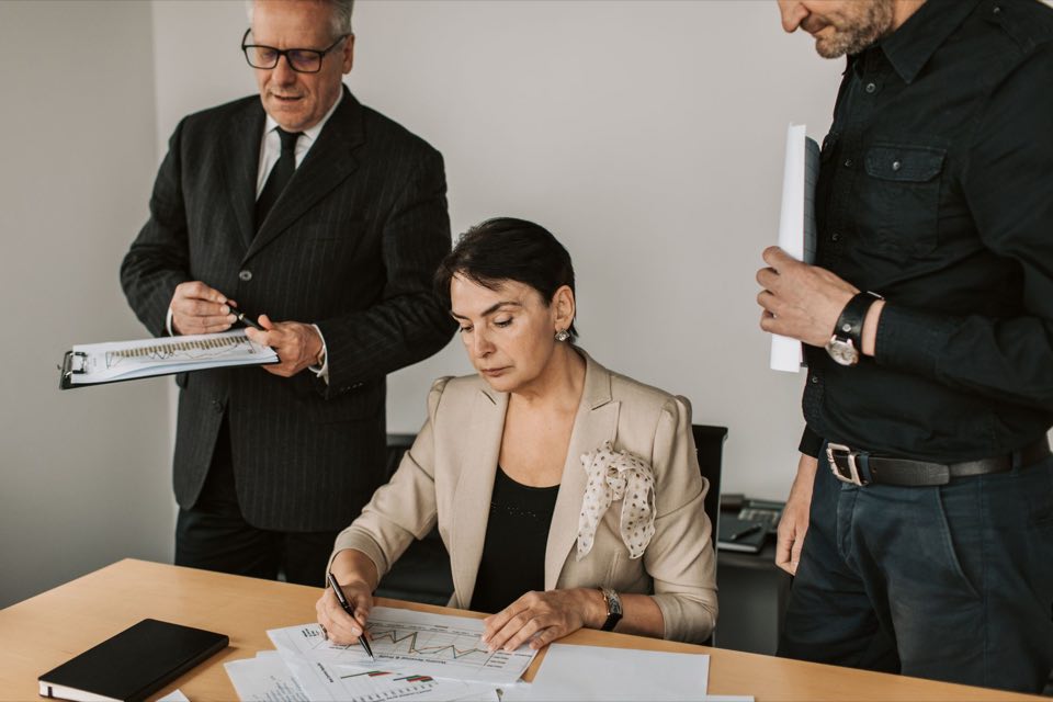 Deal team reviewing financial documents together