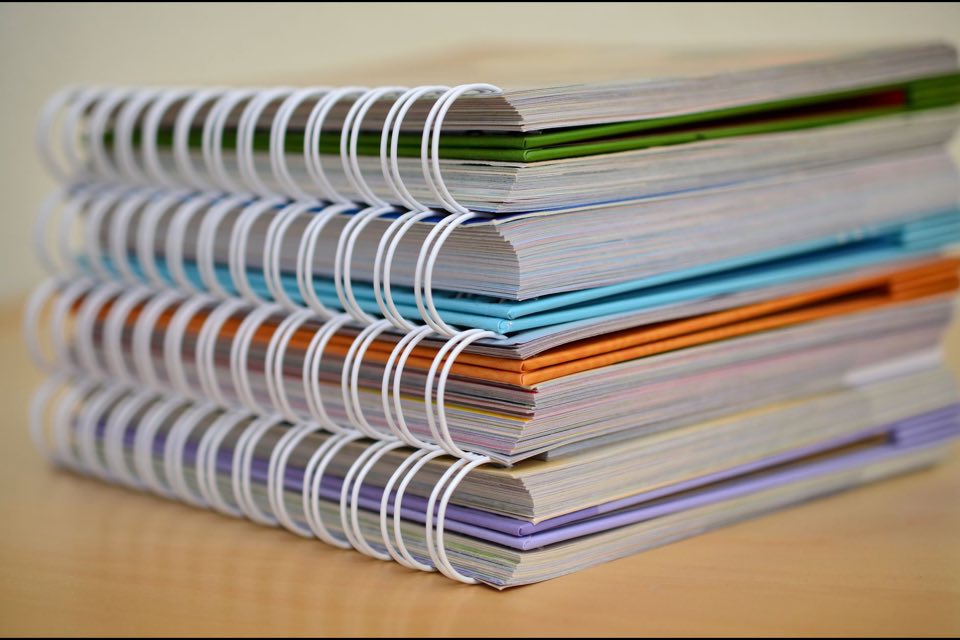 Stacked bound submission volumes in colour-coded covers