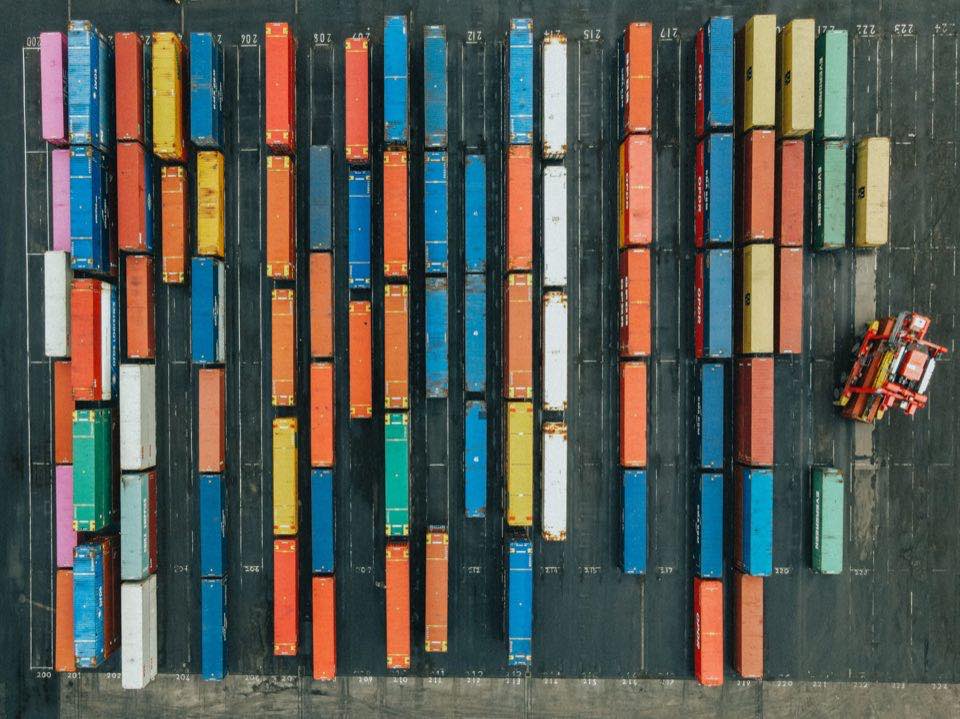 Aerial view of shipping containers stacked at a logistics hub