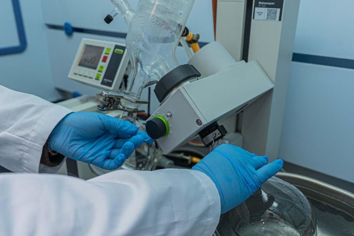 A scientist operating a rotary evaporator in a pharmaceutical laboratory