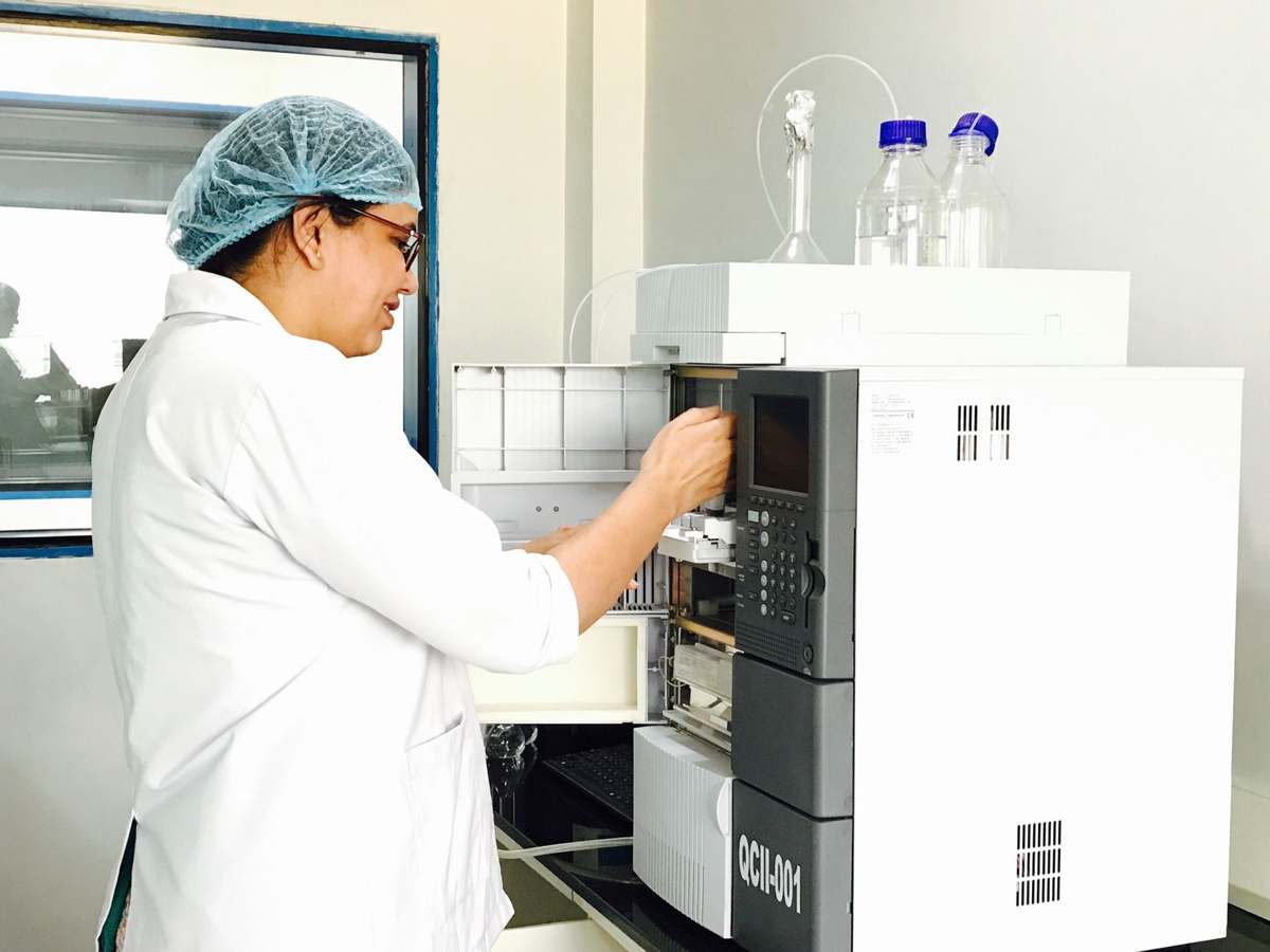 A scientist operating analytical instrumentation in a pharmaceutical laboratory