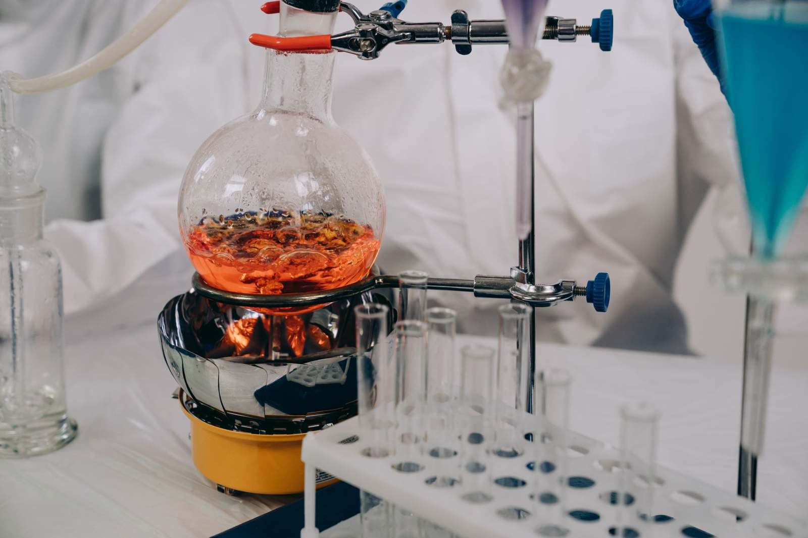 A chemist running a synthesis reaction in a laboratory flask