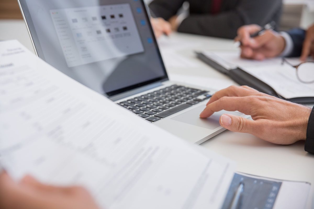A team preparing a regulatory submission on a laptop