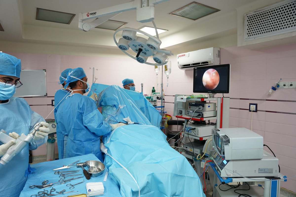 Healthcare professionals performing a laparoscopic procedure with monitors