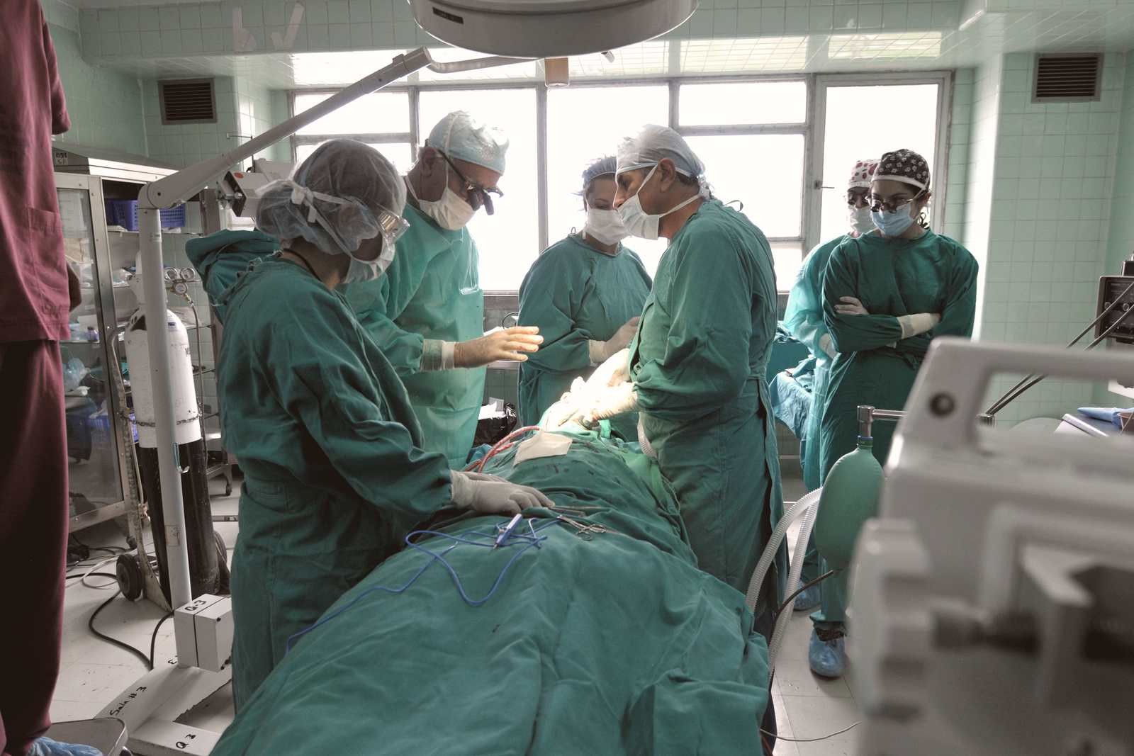 A surgical team focused on a procedure in an operating room
