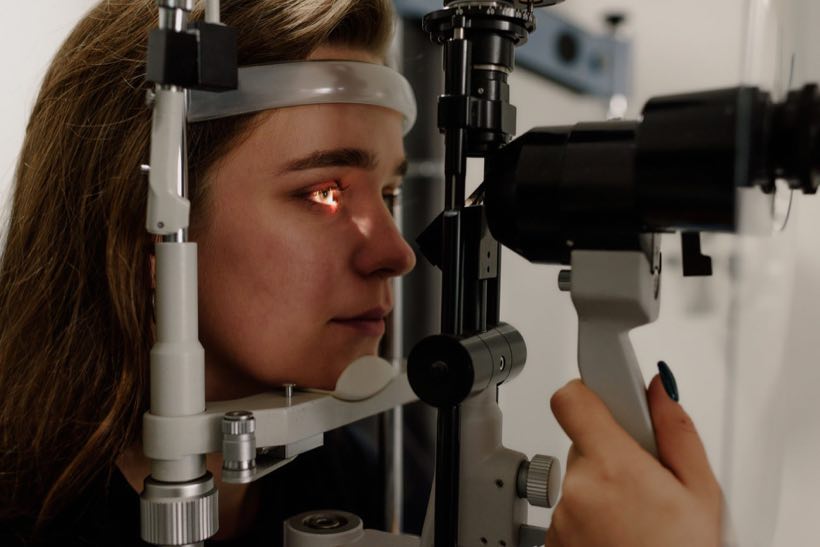 Patient examined at a slit lamp in an eye clinic
