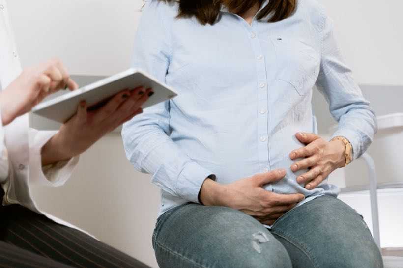 Expecting mother reviewing results with her clinician