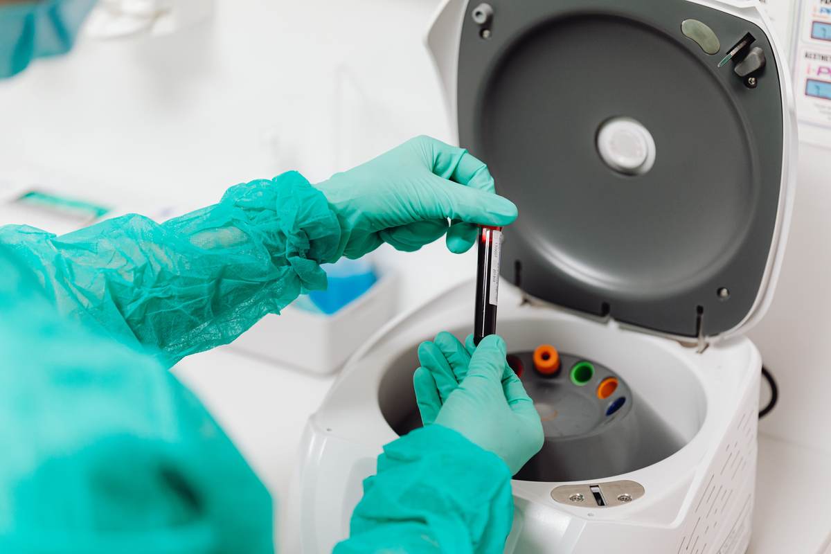 A lab technician operating processing equipment