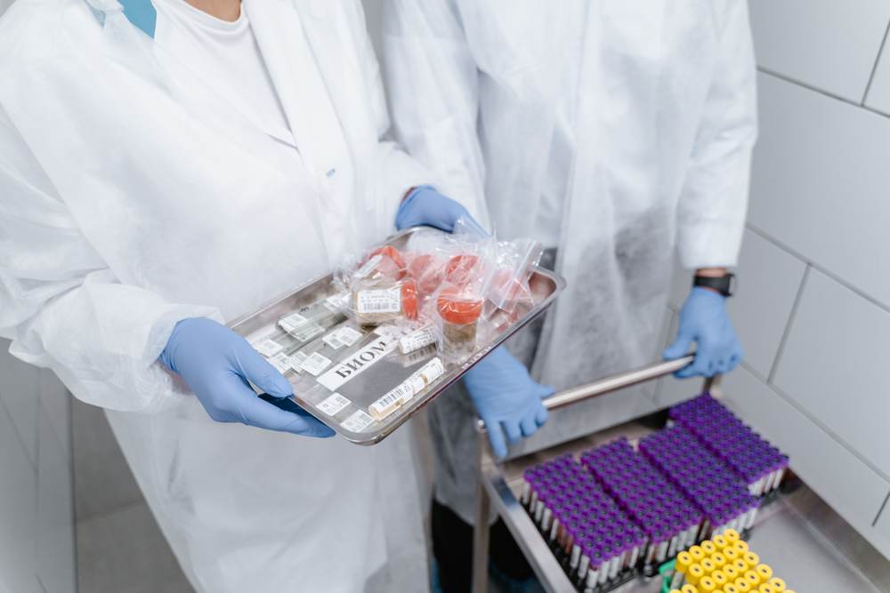 Scientists managing medical samples in protective gear