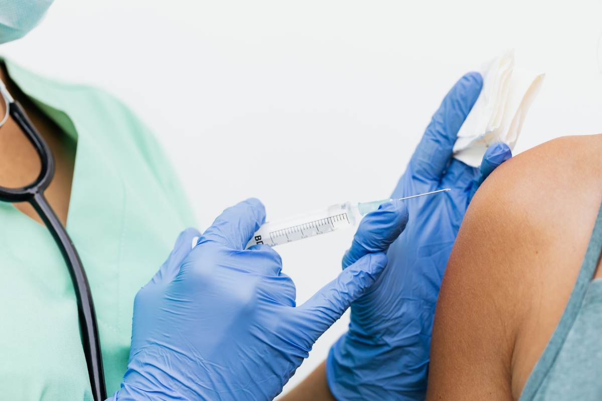Close-up of a nurse in gloves giving a vaccination