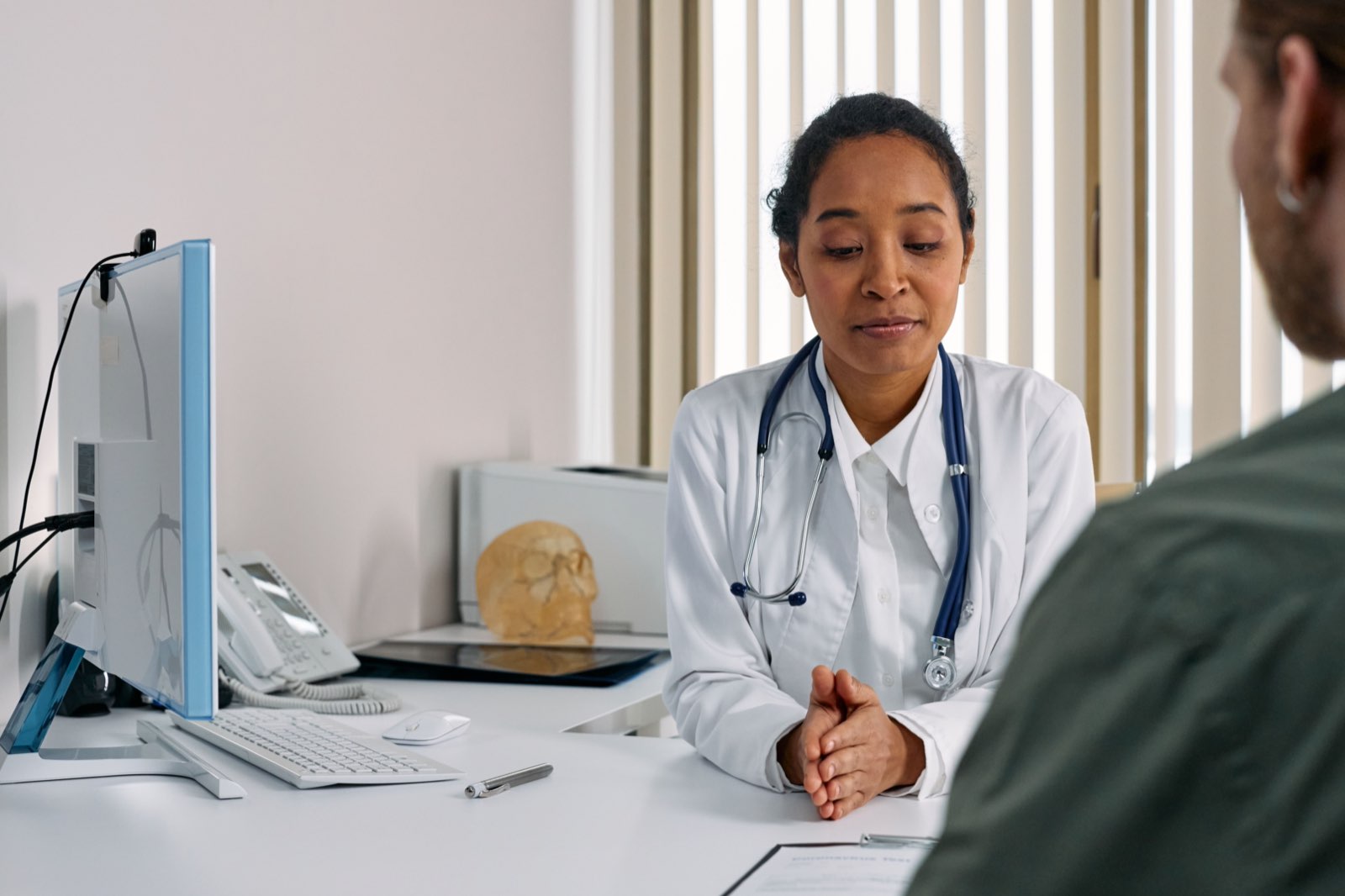 A physician in consultation with a woman in a modern clinic